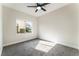 Bedroom featuring carpet, a ceiling fan, and a window with neighborhood views at 9705 Standard Ave, Las Vegas, NV 89129