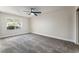 Neutral bedroom featuring carpeted floors, ceiling fan, and bright window at 9705 Standard Ave, Las Vegas, NV 89129