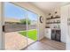 Inviting dining area with backyard access, floating shelves, and a stylish beverage center with a wine cooler at 9705 Standard Ave, Las Vegas, NV 89129