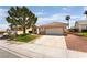 Charming single-story home featuring a well-maintained lawn, desert landscaping, and a two-car garage at 9705 Standard Ave, Las Vegas, NV 89129