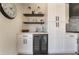 Stylish kitchen with white cabinets, dark hardware, modern stainless steel appliances, and a wine fridge at 9705 Standard Ave, Las Vegas, NV 89129