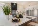 Bright kitchen with white cabinets, a large island with bar seating, and modern stainless steel appliances at 9705 Standard Ave, Las Vegas, NV 89129
