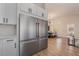 Kitchen features a stainless steel refrigerator and seamless access to the dining area with views of the backyard at 9705 Standard Ave, Las Vegas, NV 89129