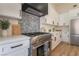 Modern kitchen with stainless steel range, sleek backsplash, and white countertops offer a functional cooking space at 9705 Standard Ave, Las Vegas, NV 89129