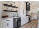 Modern kitchen featuring stainless steel appliances, sleek white cabinetry, and a chic beverage center with a wine cooler at 9705 Standard Ave, Las Vegas, NV 89129