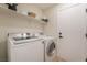 Convenient laundry room with modern washer and dryer, shelving, and ample storage at 9705 Standard Ave, Las Vegas, NV 89129