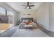 Bright main bedroom featuring a sliding glass door, soft carpet, and a decorative wood headboard at 9705 Standard Ave, Las Vegas, NV 89129