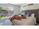 Cozy main bedroom featuring a sliding glass door with backyard views and a decorative wood headboard at 9705 Standard Ave, Las Vegas, NV 89129