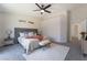 Spacious main bedroom featuring a sliding glass door, soft carpet, decorative wood headboard, and a ceiling fan at 9705 Standard Ave, Las Vegas, NV 89129
