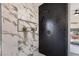 Modern shower featuring elegant marble tile, a niche for plants, and sleek black herringbone tile at 9705 Standard Ave, Las Vegas, NV 89129