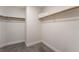 Spacious walk-in closet with carpet floors and ample shelving and rod space for storage at 9705 Standard Ave, Las Vegas, NV 89129