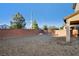 Low maintenance backyard with patio and tall brick wall at 9846 Sunriver Meadows Ave, Las Vegas, NV 89148