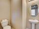 Powder room featuring a pedestal sink, and toilet at 9846 Sunriver Meadows Ave, Las Vegas, NV 89148