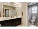 Bathroom with double vanity, large mirror, and shower/tub combination at 9846 Sunriver Meadows Ave, Las Vegas, NV 89148