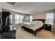 Bright main bedroom with neutral walls, carpet, large windows and a dark wood dresser at 9846 Sunriver Meadows Ave, Las Vegas, NV 89148
