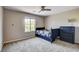 Bedroom with a large window, a full bed, dresser, and neutral carpet at 9846 Sunriver Meadows Ave, Las Vegas, NV 89148