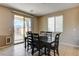 Cozy dining area with a wooden table, six chairs, and sliding glass door at 9846 Sunriver Meadows Ave, Las Vegas, NV 89148