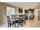 Dining space with dark wood table adjacent to open-concept kitchen at 9846 Sunriver Meadows Ave, Las Vegas, NV 89148