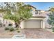 Charming two-story home with a two car garage, desert landscaping and brick paver driveway at 9846 Sunriver Meadows Ave, Las Vegas, NV 89148