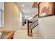 View of the home's entry foyer and stairs with tile flooring and neutral paint at 9846 Sunriver Meadows Ave, Las Vegas, NV 89148