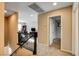 A hallway with a decorative wrought iron railing overlooks the living room with a television and comfortable seating at 9846 Sunriver Meadows Ave, Las Vegas, NV 89148
