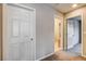 Hallway featuring neutral paint and carpet, with doors leading to various rooms at 9846 Sunriver Meadows Ave, Las Vegas, NV 89148
