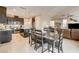 Open-concept kitchen and dining area with granite countertops and stainless steel appliances at 9846 Sunriver Meadows Ave, Las Vegas, NV 89148