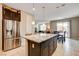 Open-concept kitchen with stainless steel appliances, island, and adjacent dining area at 9846 Sunriver Meadows Ave, Las Vegas, NV 89148