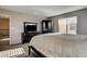 Bright and spacious main bedroom with dark furniture set and natural light at 9846 Sunriver Meadows Ave, Las Vegas, NV 89148