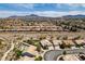 The aerial view shows a desert landscape neighborhood with mountain views in the distance at 1017 Guided Dancer Ave, Henderson, NV 89015