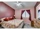 Comfortable bedroom features a queen-sized bed, shuttered window with burgundy curtains, and neutral decor at 1017 Guided Dancer Ave, Henderson, NV 89015