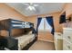 A bedroom features a bunk bed, neutral carpet, and a TV mounted on the wall at 1017 Guided Dancer Ave, Henderson, NV 89015