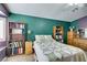 Comfortable bedroom with teal accent wall and bookshelves offering ample storage at 1017 Guided Dancer Ave, Henderson, NV 89015