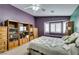 Spacious bedroom with purple accent wall and window seat featuring built-in shelving at 1017 Guided Dancer Ave, Henderson, NV 89015