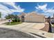 Charming single-story home with a well-manicured lawn, desert landscaping, and two-car garage at 1017 Guided Dancer Ave, Henderson, NV 89015