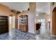 Hallway with tiled flooring, decorative niches, and view into the living room at 1017 Guided Dancer Ave, Henderson, NV 89015