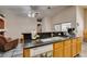 A modern kitchen features oak cabinets, granite countertops, and an open layout perfect for entertaining guests at 1017 Guided Dancer Ave, Henderson, NV 89015