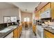 Bright kitchen with oak cabinets, granite countertops, stainless steel appliances, and a cozy dining nook at 1017 Guided Dancer Ave, Henderson, NV 89015