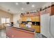 A well-appointed kitchen connects to the dining area and features oak cabinets and granite countertops at 1017 Guided Dancer Ave, Henderson, NV 89015