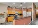 A bright kitchen features oak cabinets, granite countertops, and a breakfast bar perfect for casual dining at 1017 Guided Dancer Ave, Henderson, NV 89015