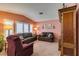 Cozy living room featuring plush seating and plantation shutters, creating a welcoming space at 1017 Guided Dancer Ave, Henderson, NV 89015
