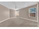 Spacious bedroom features carpet, neutral paint, ceiling fan, and dual windows providing plenty of natural light at 104 Hutton Ln, Las Vegas, NV 89145