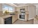 Cozy kitchen featuring tile flooring, neutral countertops and cabinets, stainless steel appliances, and a double basin sink at 104 Hutton Ln, Las Vegas, NV 89145