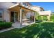 A backyard with artificial turf, a covered patio, and comfortable seating, perfect for outdoor relaxation at 10749 Turquoise Valley Dr, Las Vegas, NV 89144