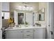 Stylish bathroom with double vanity, modern lighting, and decorative accents at 10749 Turquoise Valley Dr, Las Vegas, NV 89144