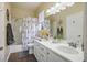 Inviting bathroom with double sinks, decorative shower curtain, and natural lighting at 10749 Turquoise Valley Dr, Las Vegas, NV 89144