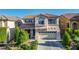 Charming two-story home features a well-manicured yard, two-car garage, and elegant architectural details at 10749 Turquoise Valley Dr, Las Vegas, NV 89144