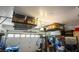 Well-organized garage with overhead storage racks and ample space for vehicles at 10749 Turquoise Valley Dr, Las Vegas, NV 89144