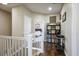 Upstairs hallway with wood floors, leading to bedrooms and a view of the staircase at 10749 Turquoise Valley Dr, Las Vegas, NV 89144