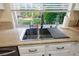 Kitchen sink with stainless steel basin, granite countertop, window, and modern faucet at 10749 Turquoise Valley Dr, Las Vegas, NV 89144